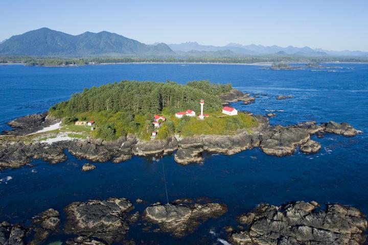 a body of water with a mountain in the ocean