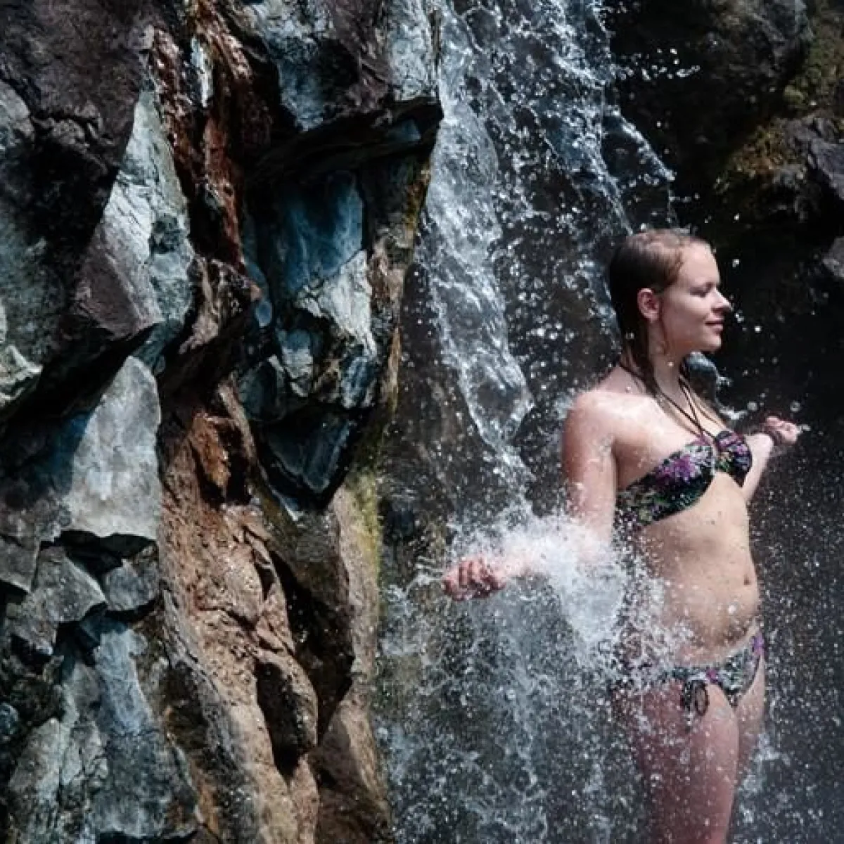 a person standing on a rock in the water