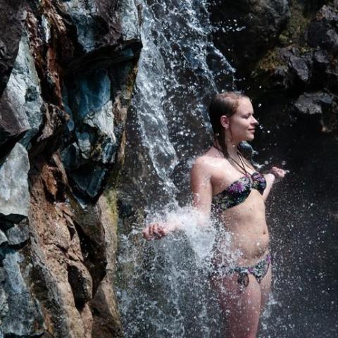 a person standing on a rock in the water