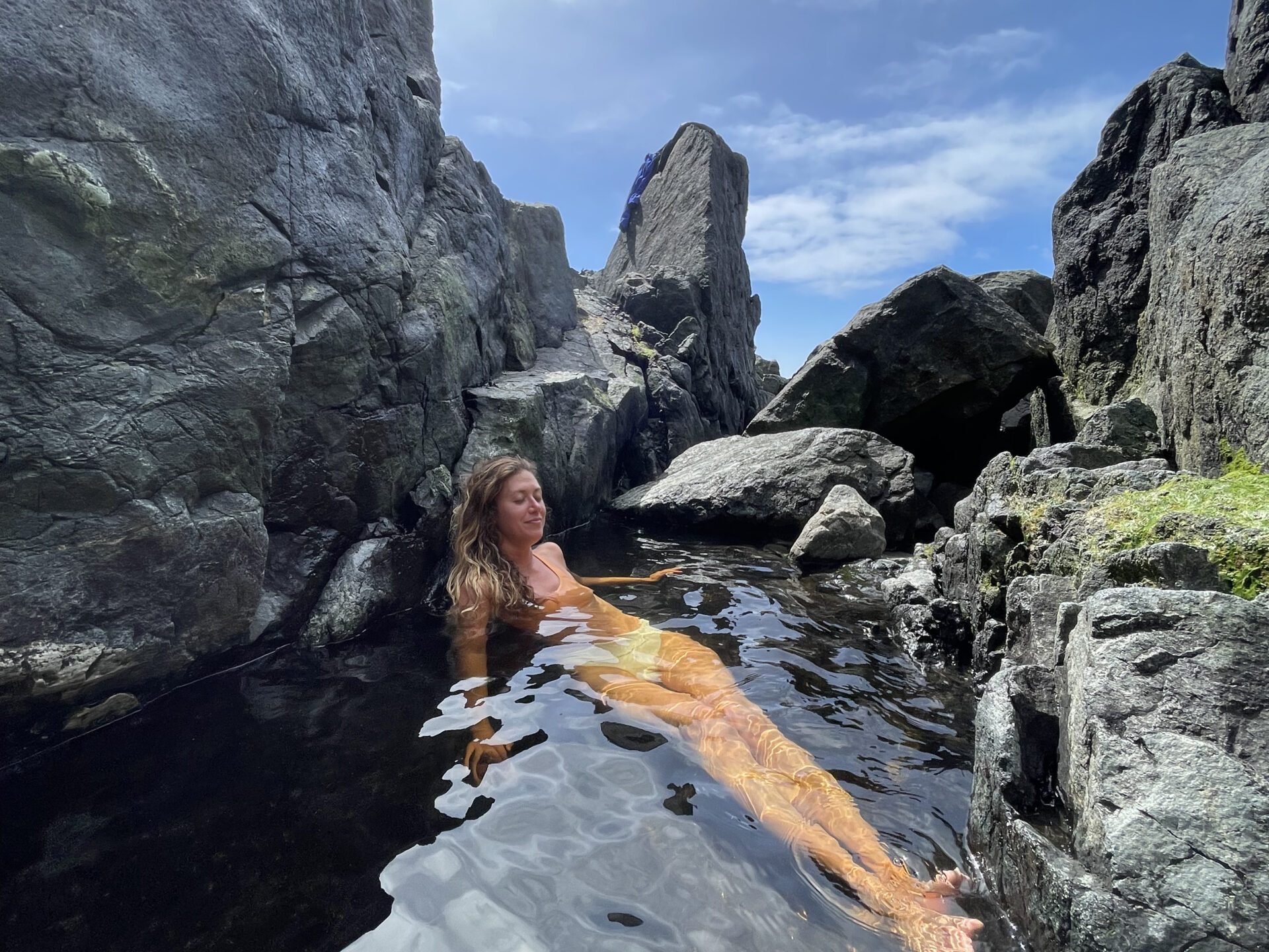 a woman enjoying the thermal pools at hot springs cove