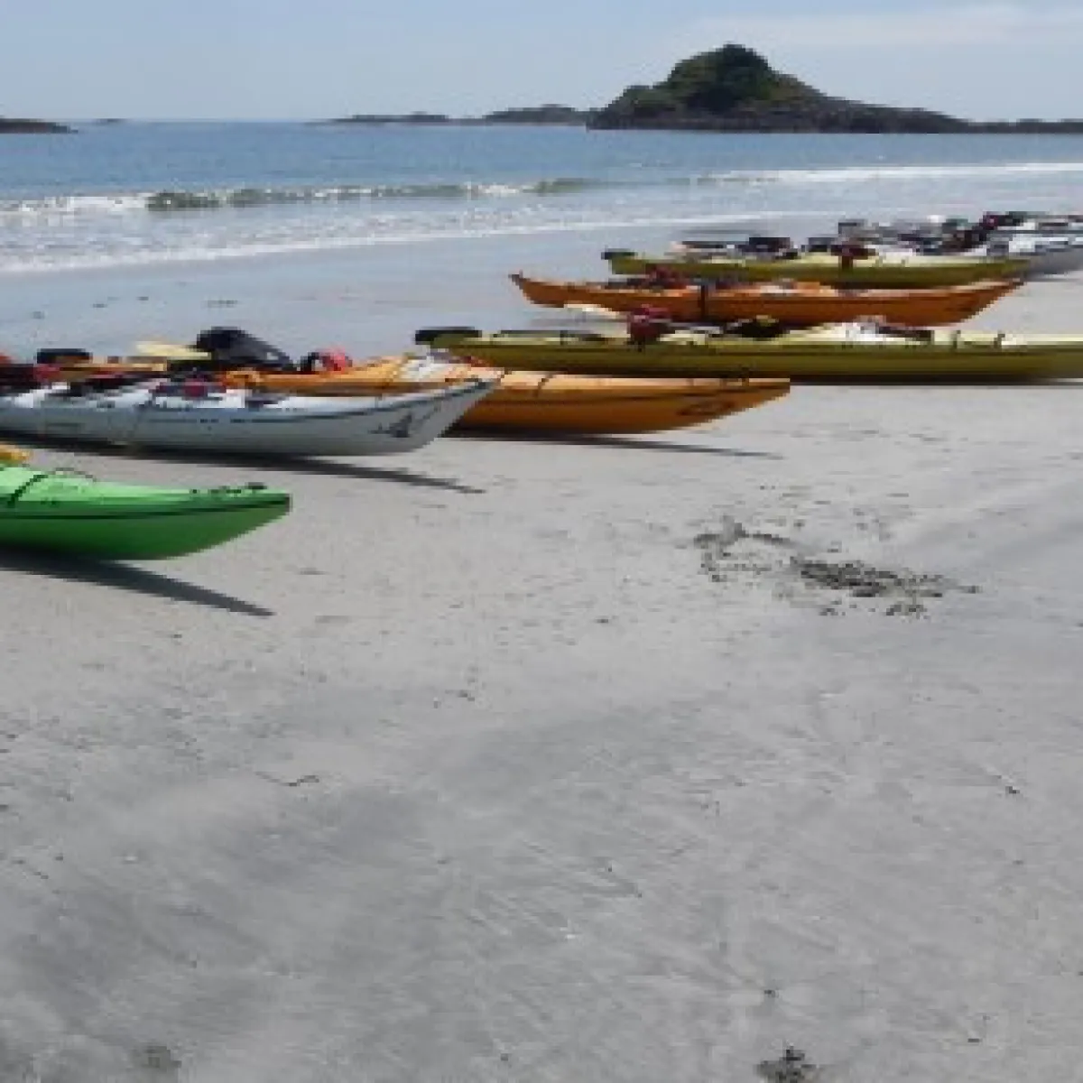 a boat sitting on top of a sandy beach