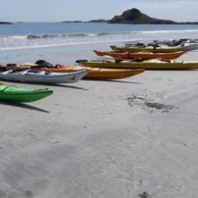 a boat sitting on top of a sandy beach