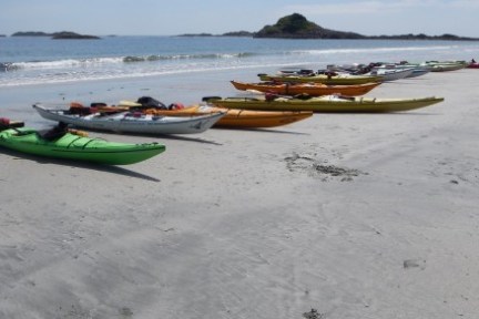 a boat sitting on top of a sandy beach