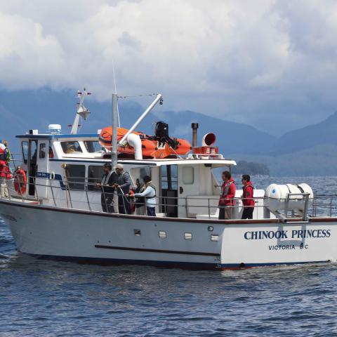 a group of people on a boat in a large body of water
