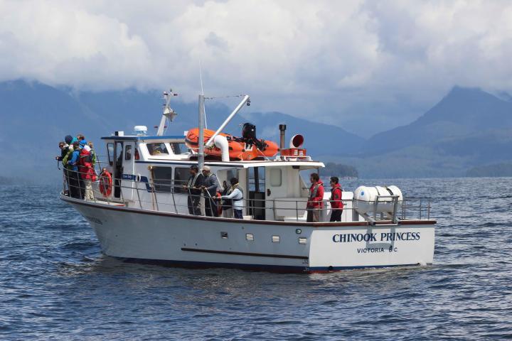 a group of people on a boat in a large body of water