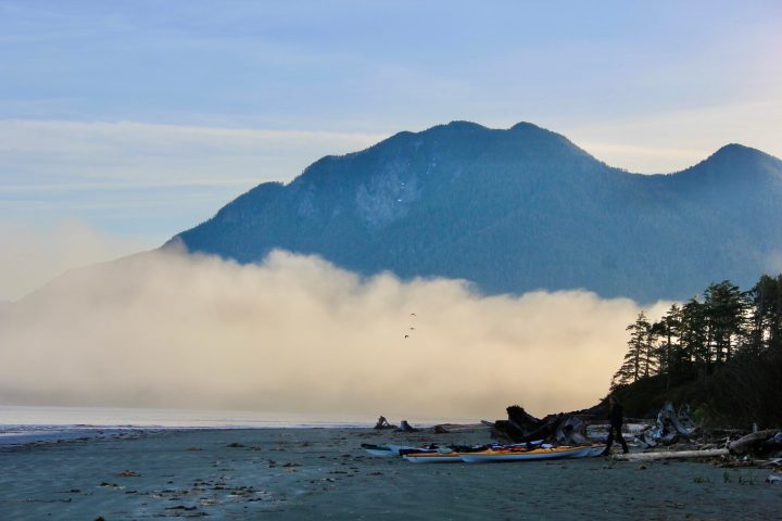 a body of water with a mountain in the background
