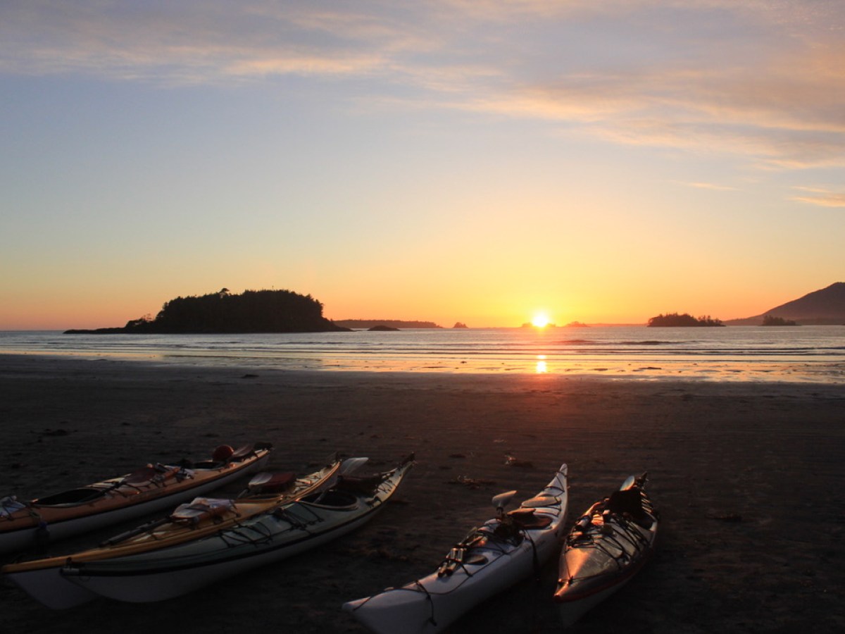 a boat on a beach near a body of water