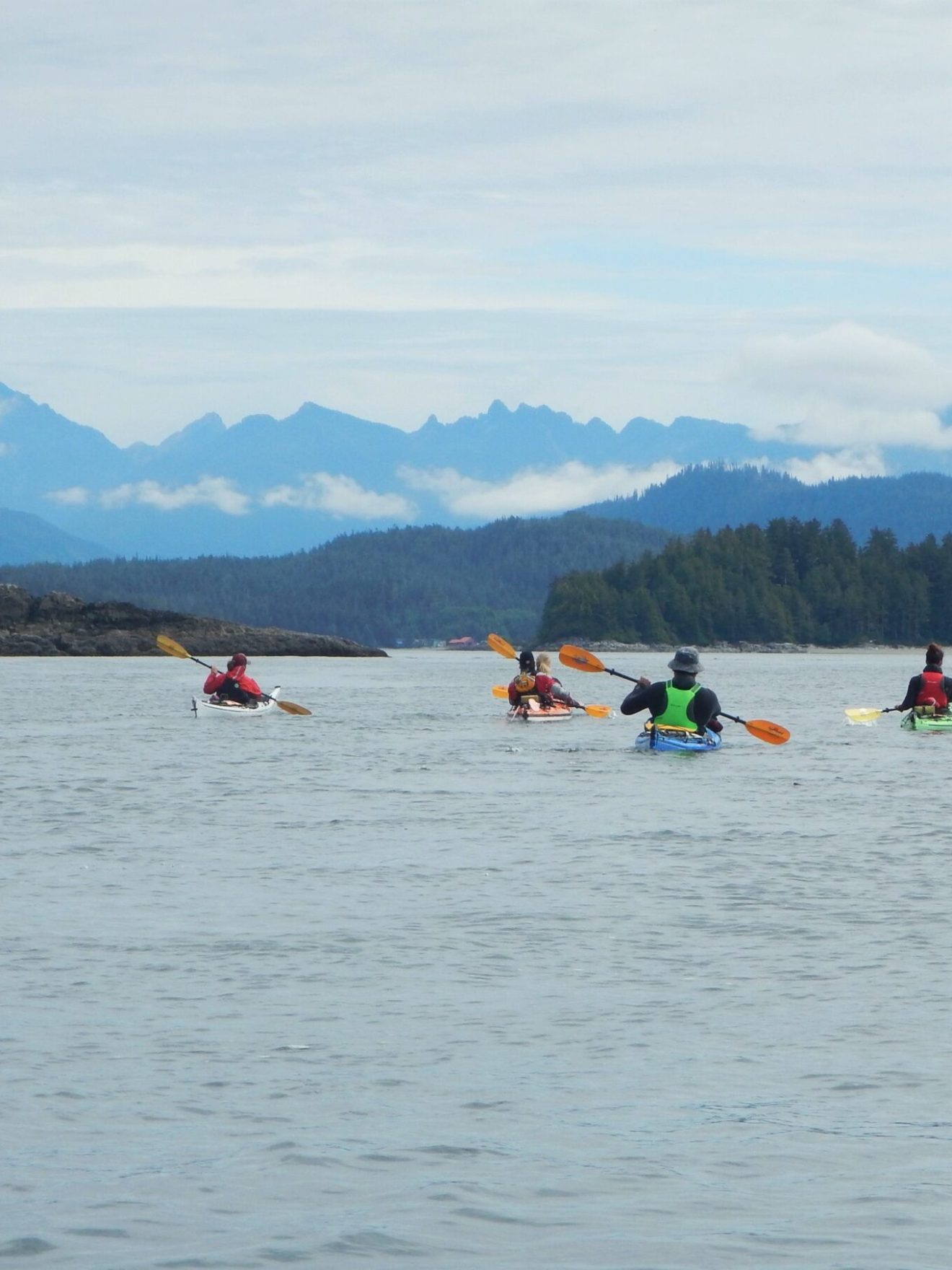 a group of people in a small boat in a body of water