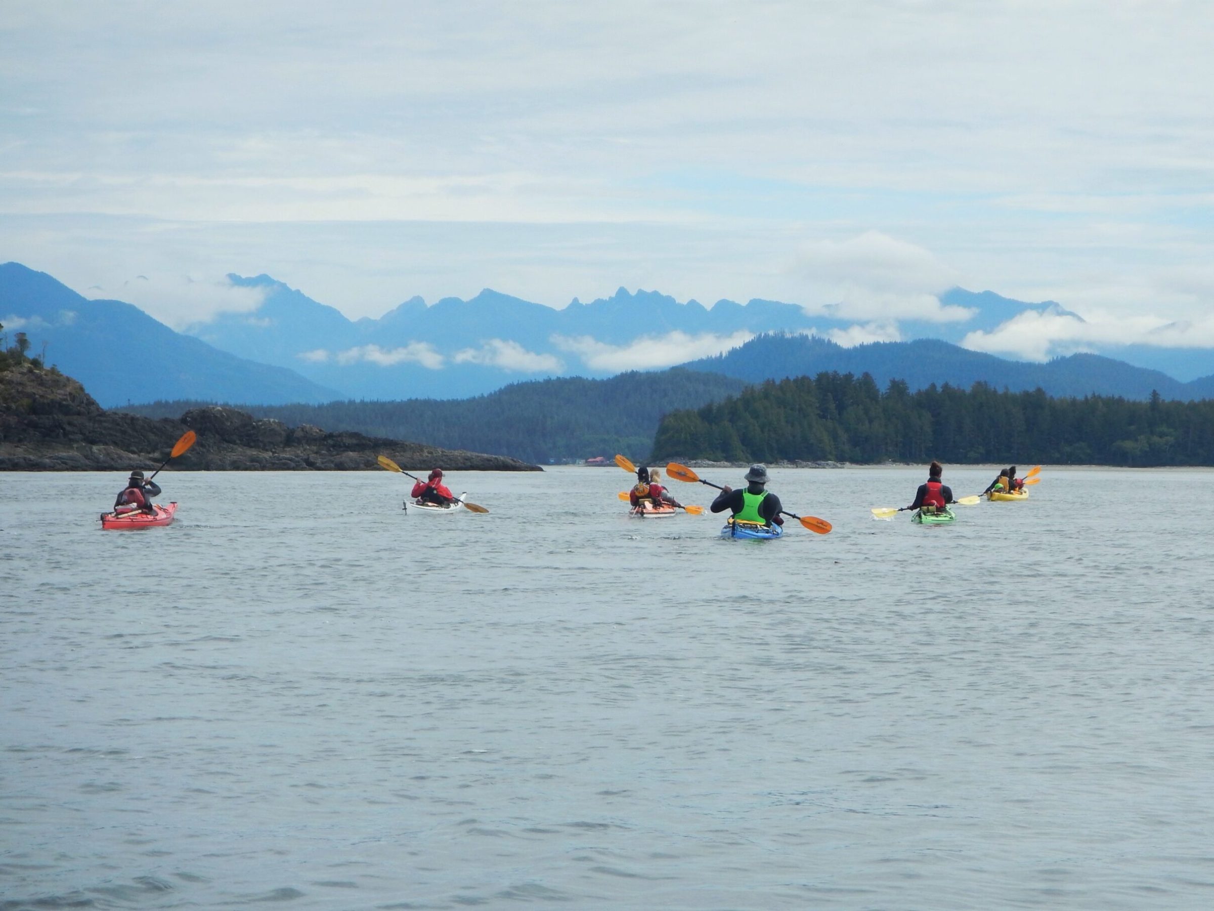 a group of people in a small boat in a body of water
