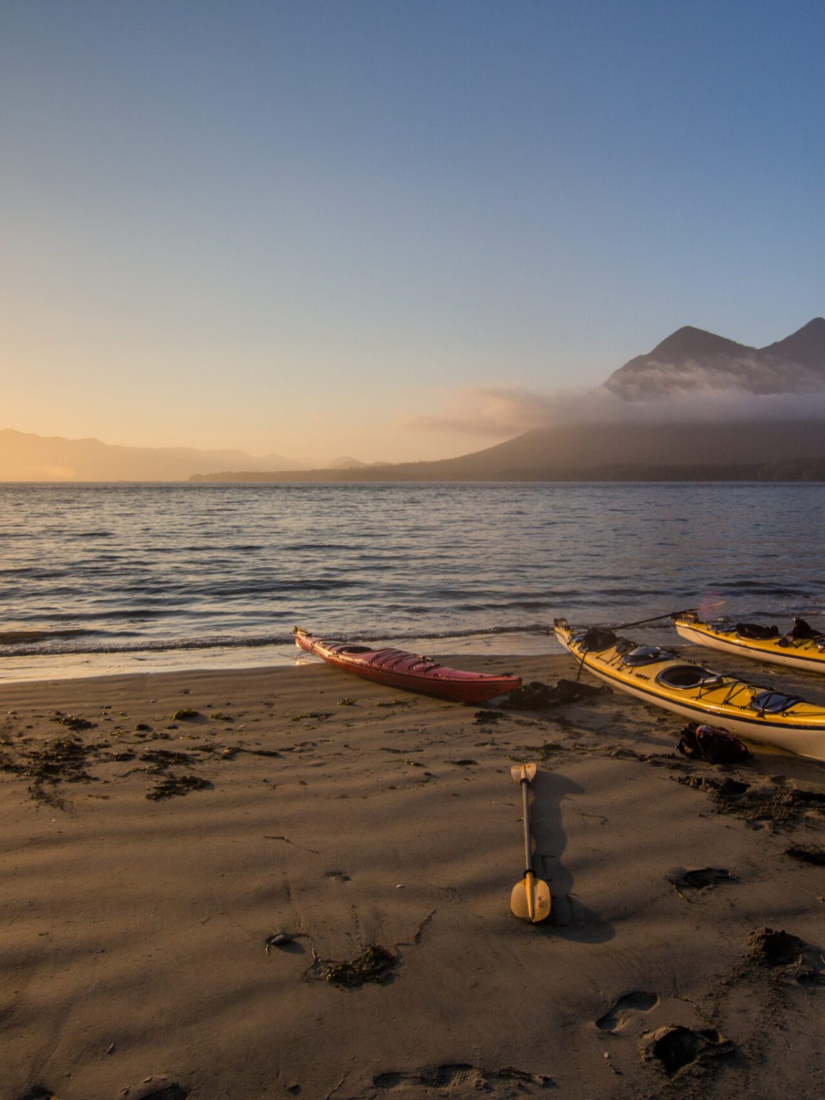 a boat sitting on top of a sandy beach