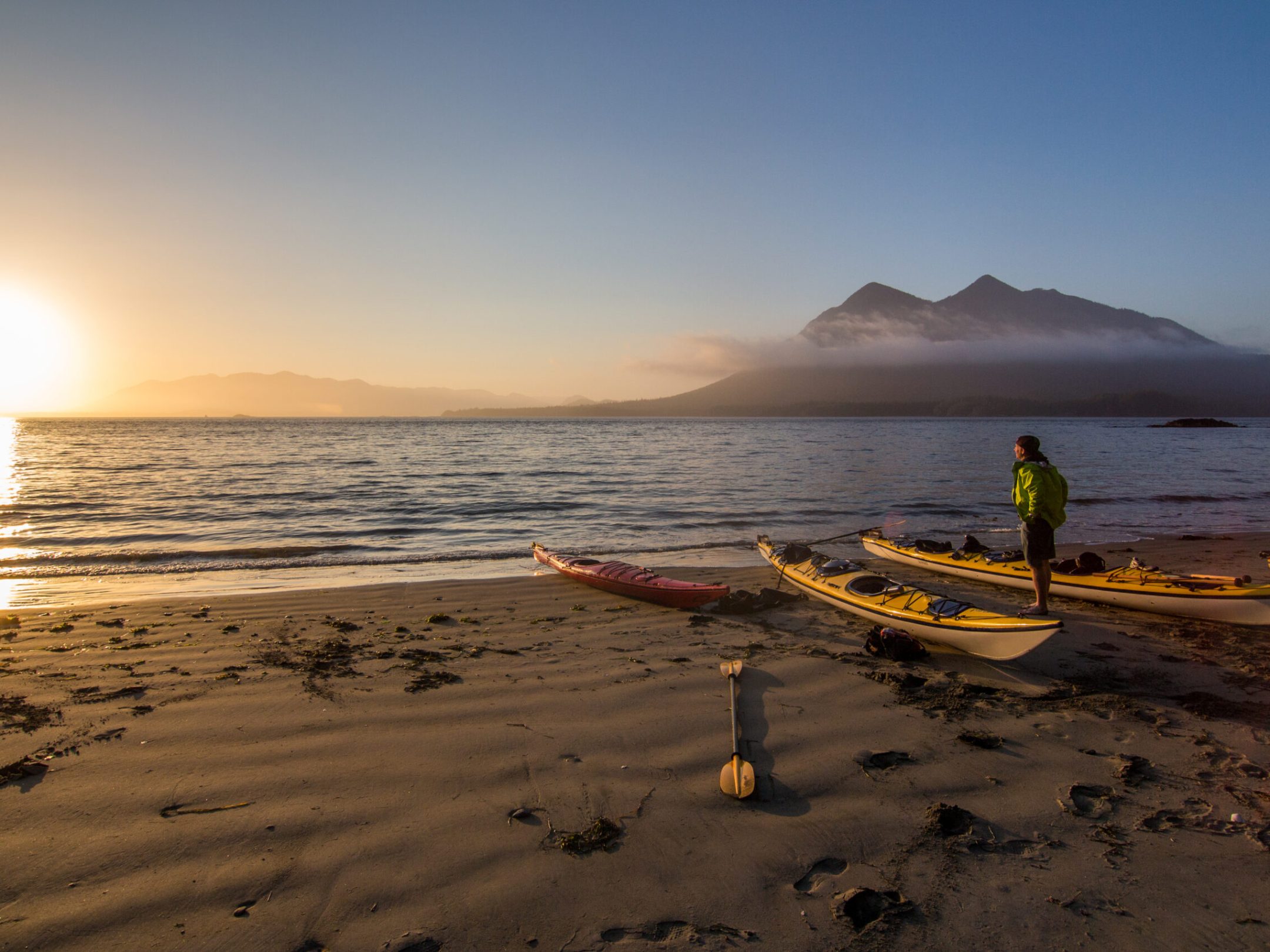 a boat sitting on top of a sandy beach