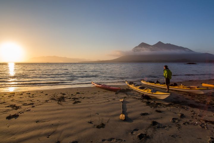 a boat sitting on top of a sandy beach